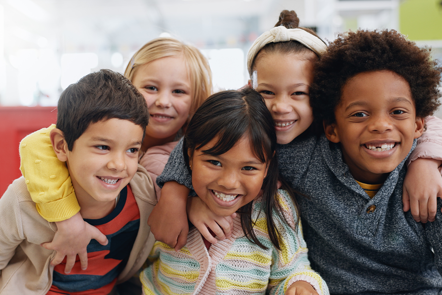 Group of children smiling together.