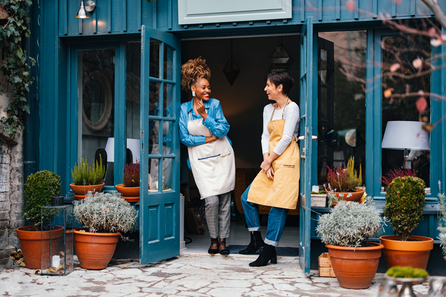 People smiling in front of their small business.