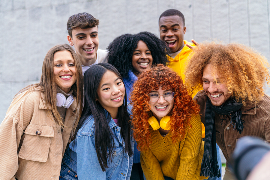 Group of young adults smiling for a picture.
